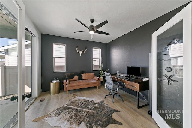 office area featuring wood finished floors, a ceiling fan, and visible vents