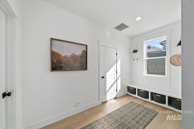 mudroom featuring baseboards, visible vents, and light wood-style flooring