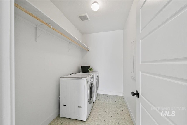 laundry area with separate washer and dryer, light floors, laundry area, baseboards, and visible vents
