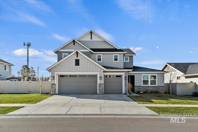craftsman inspired home featuring fence, stone siding, and board and batten siding