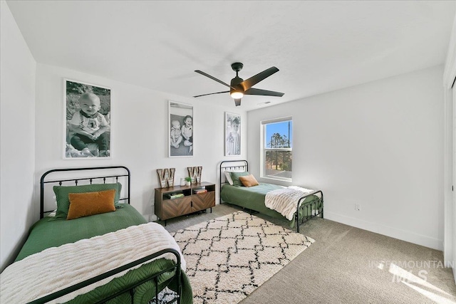 bedroom featuring baseboards, a ceiling fan, and carpet