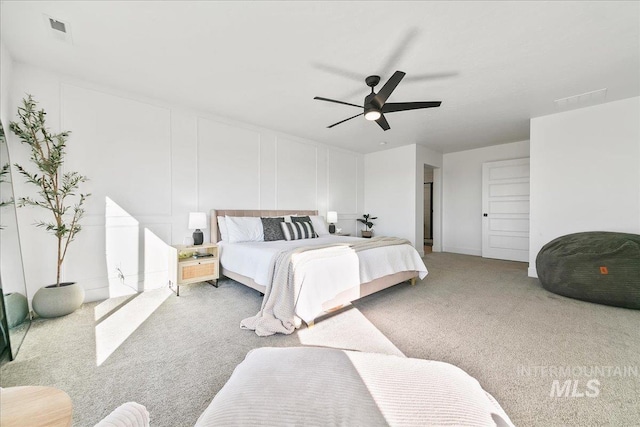 carpeted bedroom with visible vents and a ceiling fan