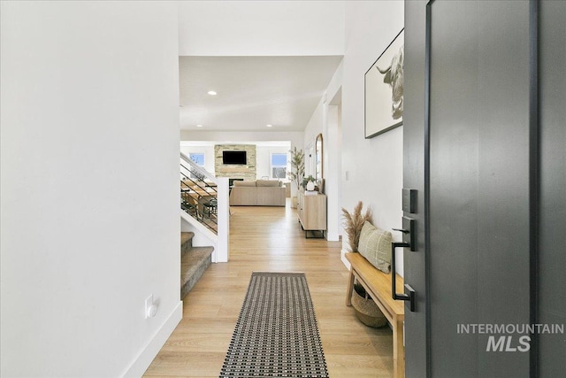 hall with recessed lighting, light wood-style floors, and stairway