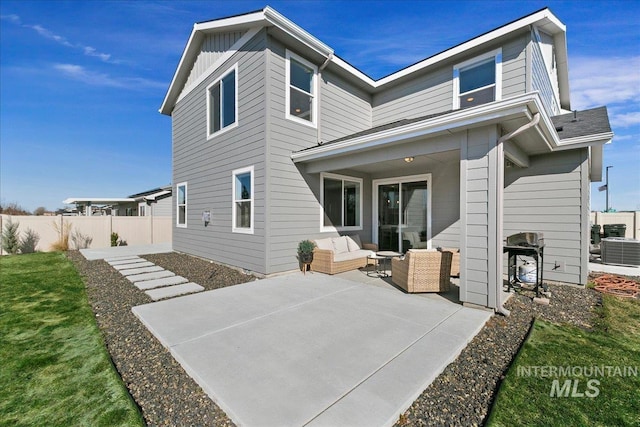 back of property featuring an outdoor hangout area, a patio area, central AC, and fence