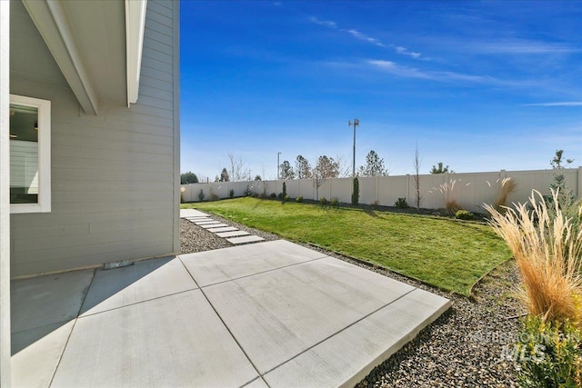 view of yard with a fenced backyard and a patio