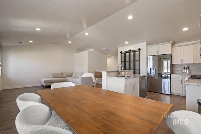 7682 W Itasco Dr, Boise, ID 83709 - dining room featuring dark wood-style flooring, baseboards, recessed lighting, and vaulted ceiling