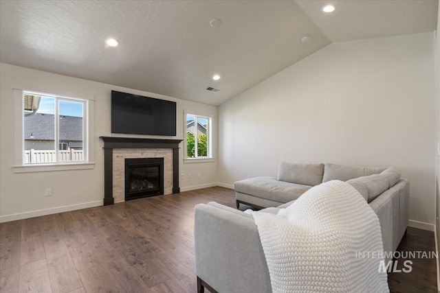 7682 W Itasco Dr, Boise, ID 83709 - living room featuring recessed lighting, baseboards, lofted ceiling, wood finished floors, and a stone fireplace