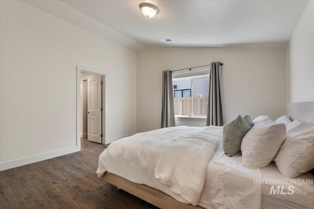 7682 W Itasco Dr, Boise, ID 83709 - bedroom with lofted ceiling, wood finished floors, and baseboards