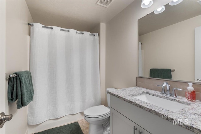 7682 W Itasco Dr, Boise, ID 83709 - full bathroom with vanity, toilet, decorative backsplash, and shower / tub combo
