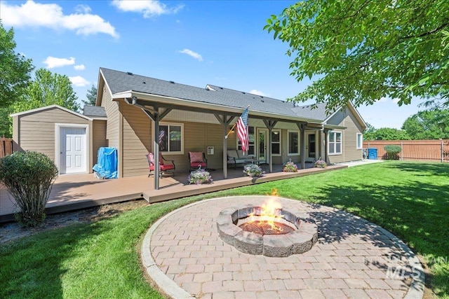 551 N Hannah Pl, Star, ID 83669 - rear view of house with a fire pit, a wooden deck, a shed, and a patio