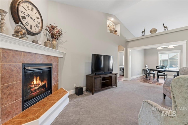 551 N Hannah Pl, Star, ID 83669 - carpeted living room with a tiled fireplace, arched walkways, and high vaulted ceiling