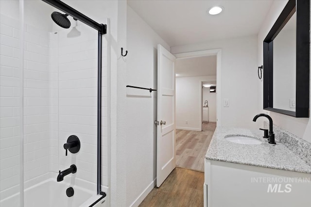 5805 W Robertson Dr, Boise, ID 83709 - bathroom featuring baseboards, vanity, wood finished floors, and shower / bath combination