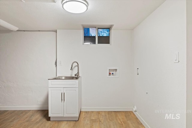 5805 W Robertson Dr, Boise, ID 83709 - clothes washing area with baseboards, a sink, and light wood finished floors