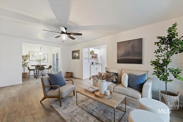 5805 W Robertson Dr, Boise, ID 83709 - living room with a ceiling fan, baseboards, and light wood-style floors