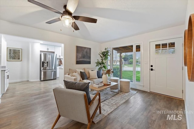 5805 W Robertson Dr, Boise, ID 83709 - living room featuring light wood-type flooring, a ceiling fan, and baseboards