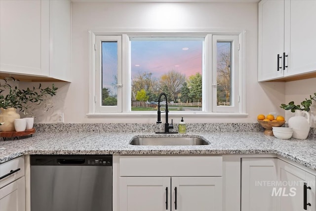 5805 W Robertson Dr, Boise, ID 83709 - kitchen with light stone countertops, dishwasher, a sink, and white cabinetry