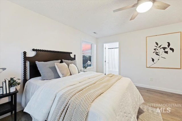 5805 W Robertson Dr, Boise, ID 83709 - bedroom with visible vents, baseboards, a ceiling fan, and wood finished floors
