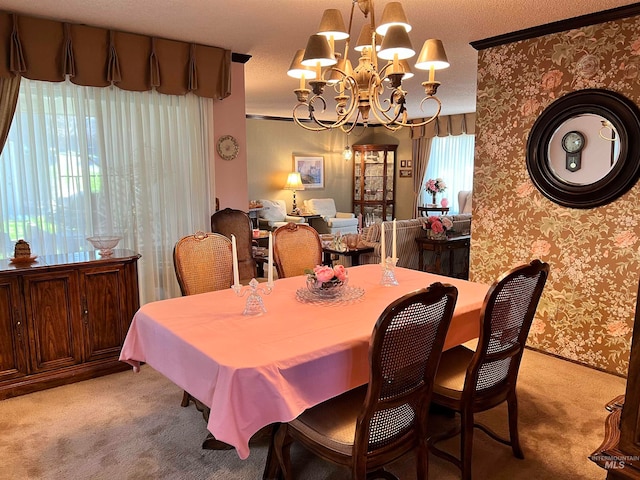 dining space featuring an inviting chandelier, light carpet, a textured ceiling, and a wealth of natural light