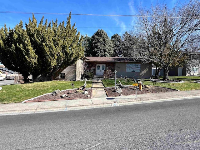 ranch-style house with a front lawn