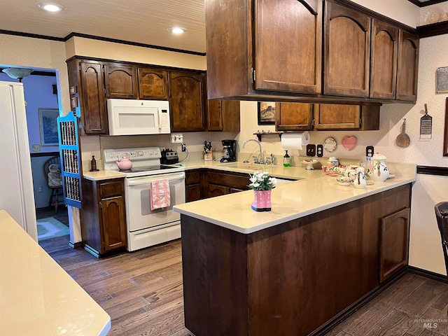 kitchen with white appliances, sink, dark hardwood / wood-style flooring, and ornamental molding