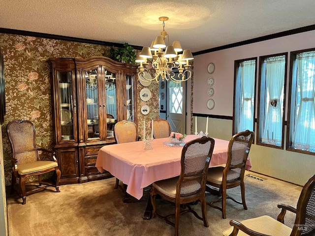 dining room featuring carpet flooring, a notable chandelier, a textured ceiling, and crown molding