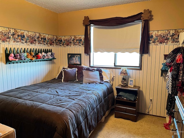 bedroom with a textured ceiling and carpet