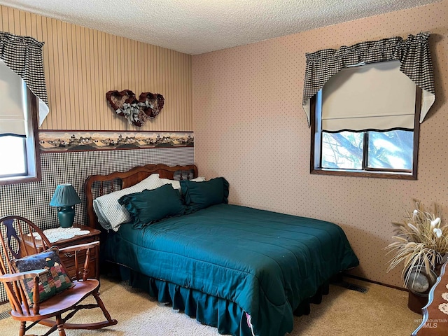 carpeted bedroom featuring a textured ceiling