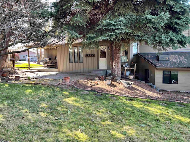 exterior space featuring a front yard and a patio