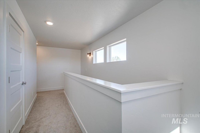 hall with recessed lighting, carpet flooring, and baseboards