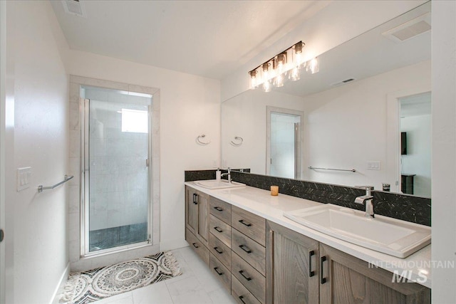 full bathroom with double vanity, visible vents, a stall shower, and a sink
