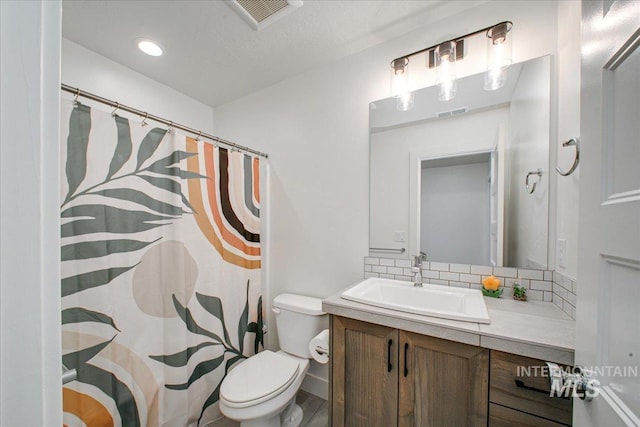 bathroom featuring backsplash, visible vents, toilet, vanity, and a shower with shower curtain