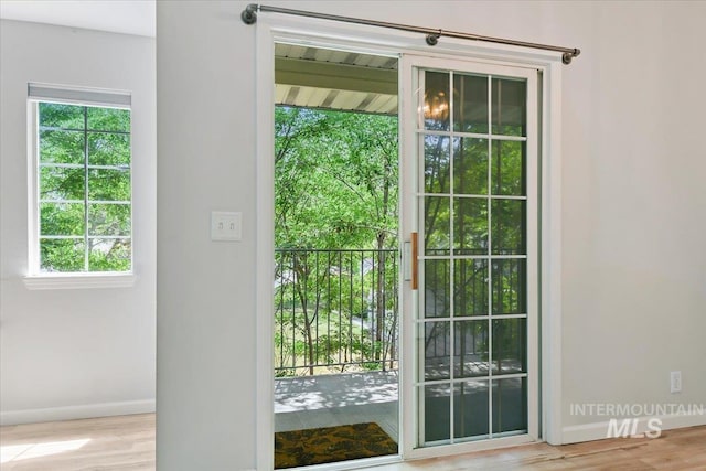 2285 S Challenger Unit 201, Boise, ID 83705 - doorway to outside with baseboards, plenty of natural light, and wood finished floors
