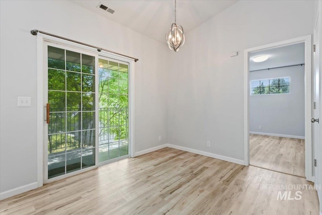 2285 S Challenger Unit 201, Boise, ID 83705 - spare room with wood finished floors, baseboards, and a chandelier