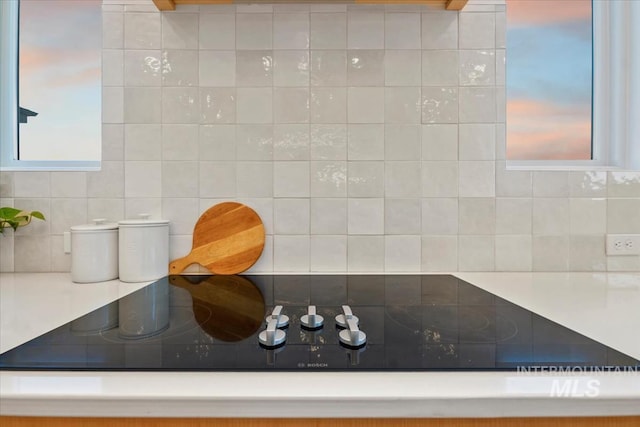 12975 Shasta Daisy Way, Nampa, ID 83686 - kitchen view of decorative backsplash, black electric cooktop, and light countertops