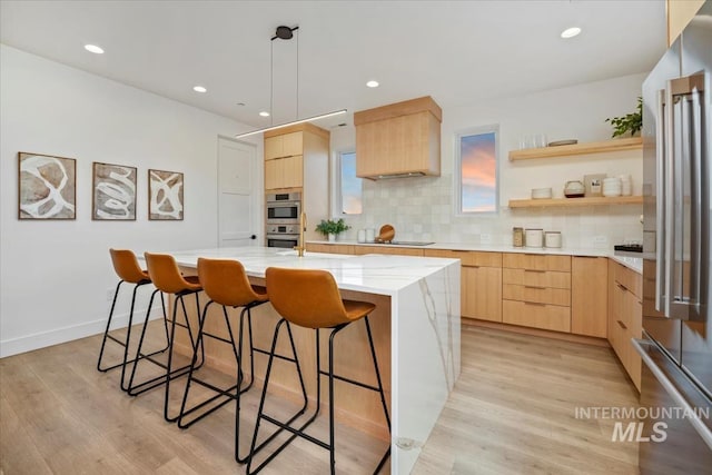 12975 Shasta Daisy Way, Nampa, ID 83686 - kitchen with light brown cabinets, modern cabinets, stainless steel appliances, a breakfast bar area, and recessed lighting