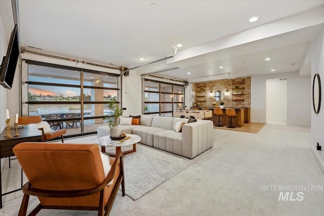 12975 Shasta Daisy Way, Nampa, ID 83686 - living area featuring light carpet, recessed lighting, baseboards, and bar area