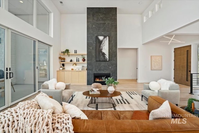 12975 Shasta Daisy Way, Nampa, ID 83686 - living room with a towering ceiling, a premium fireplace, and wood finished floors