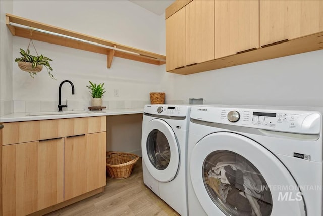 12975 Shasta Daisy Way, Nampa, ID 83686 - laundry area with cabinet space, washer and dryer, and light wood finished floors
