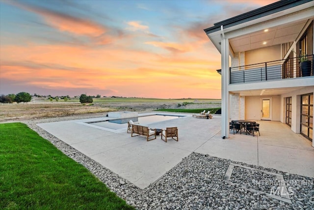 12975 Shasta Daisy Way, Nampa, ID 83686 - view of patio featuring a balcony, a pool with connected hot tub, and outdoor dining area