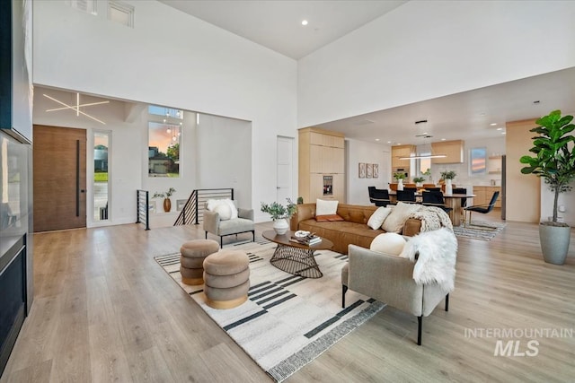 12975 Shasta Daisy Way, Nampa, ID 83686 - living room featuring light wood-type flooring, a towering ceiling, and recessed lighting
