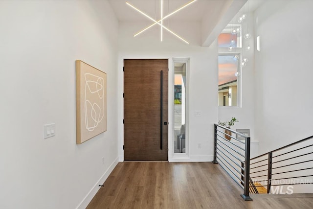 12975 Shasta Daisy Way, Nampa, ID 83686 - entrance foyer with wood finished floors, baseboards, and a chandelier