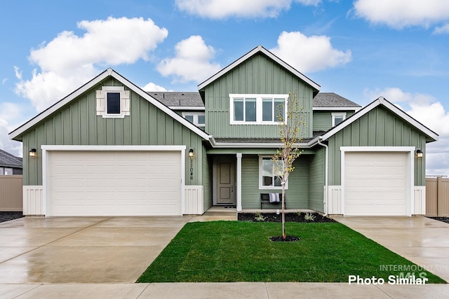 craftsman house with a garage and a front lawn