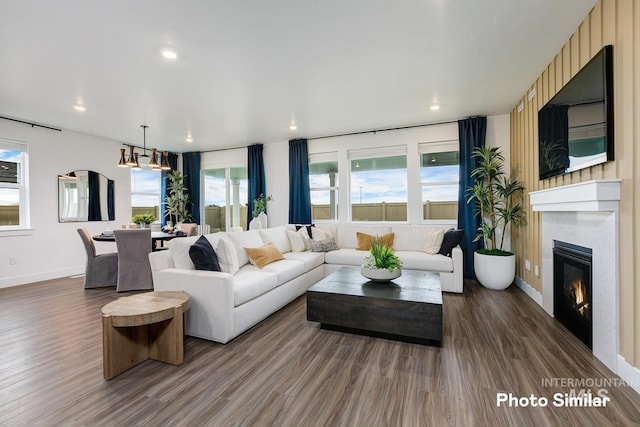 living room featuring hardwood / wood-style flooring and an inviting chandelier