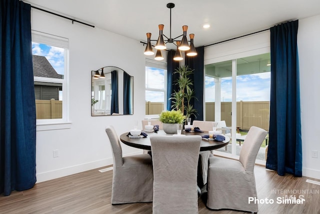 dining room featuring a chandelier and hardwood / wood-style floors