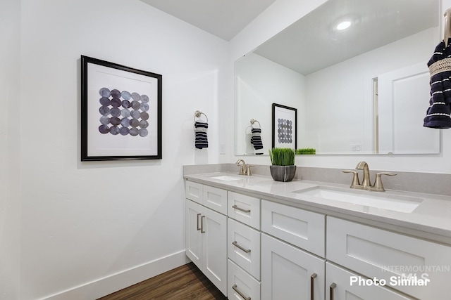 bathroom with hardwood / wood-style floors and vanity