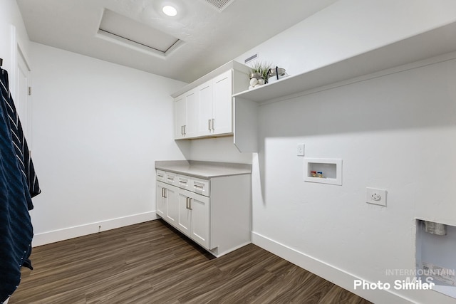 laundry area featuring hookup for a washing machine, cabinets, dark hardwood / wood-style floors, and hookup for an electric dryer