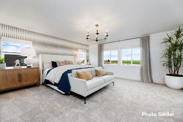 bedroom featuring light carpet and an inviting chandelier