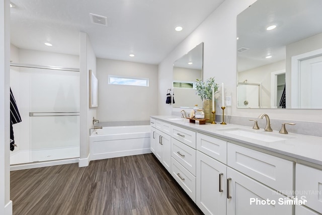 bathroom featuring vanity, shower with separate bathtub, and hardwood / wood-style flooring