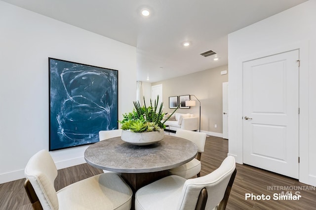 dining space with dark hardwood / wood-style flooring