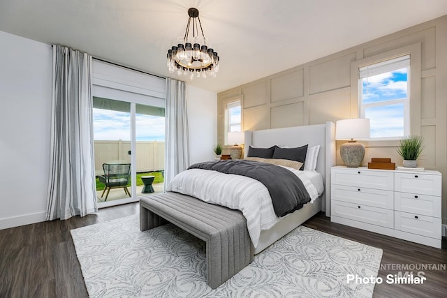 bedroom featuring a notable chandelier, access to exterior, and dark wood-type flooring